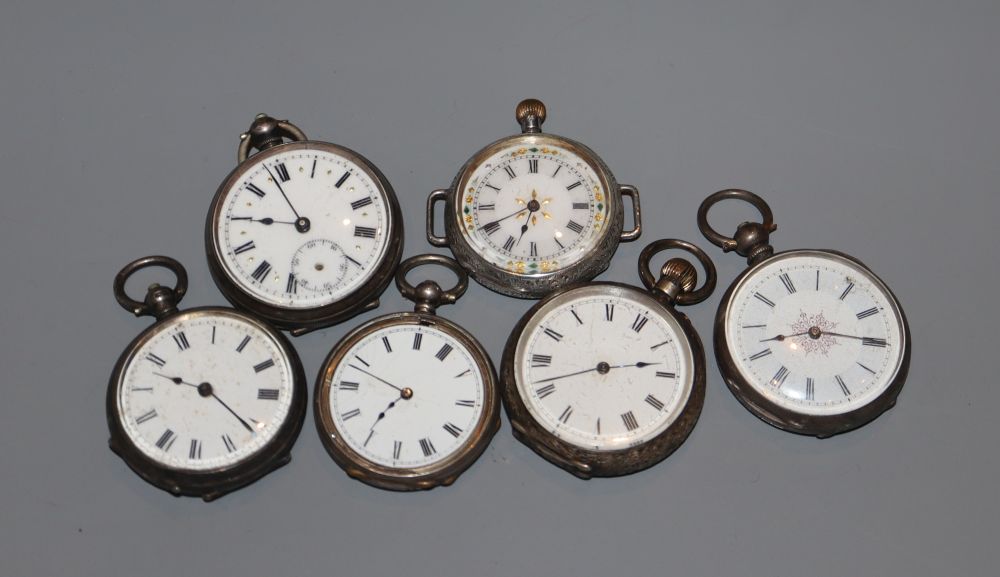 Five assorted early 20th century silver or white metal fob watches and a white metal wrist watch,